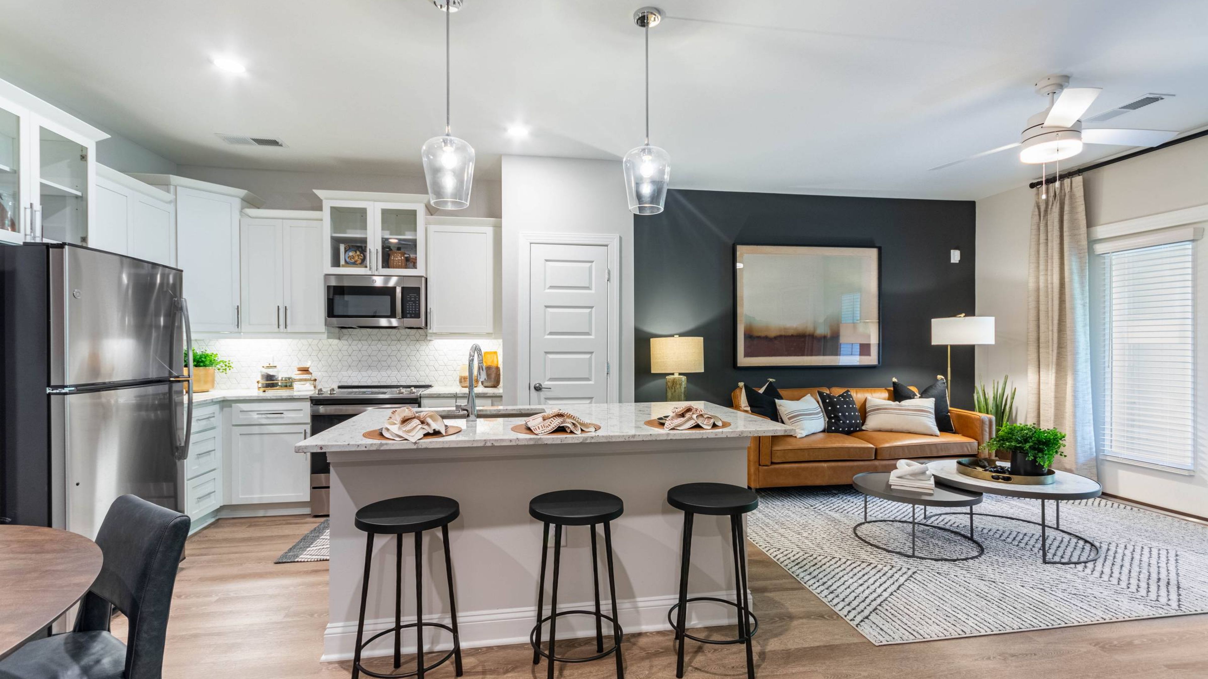 Hawthorne Northwest apartment kitchen with large island, pendant lighting, a pantry, and stainless steel appliances