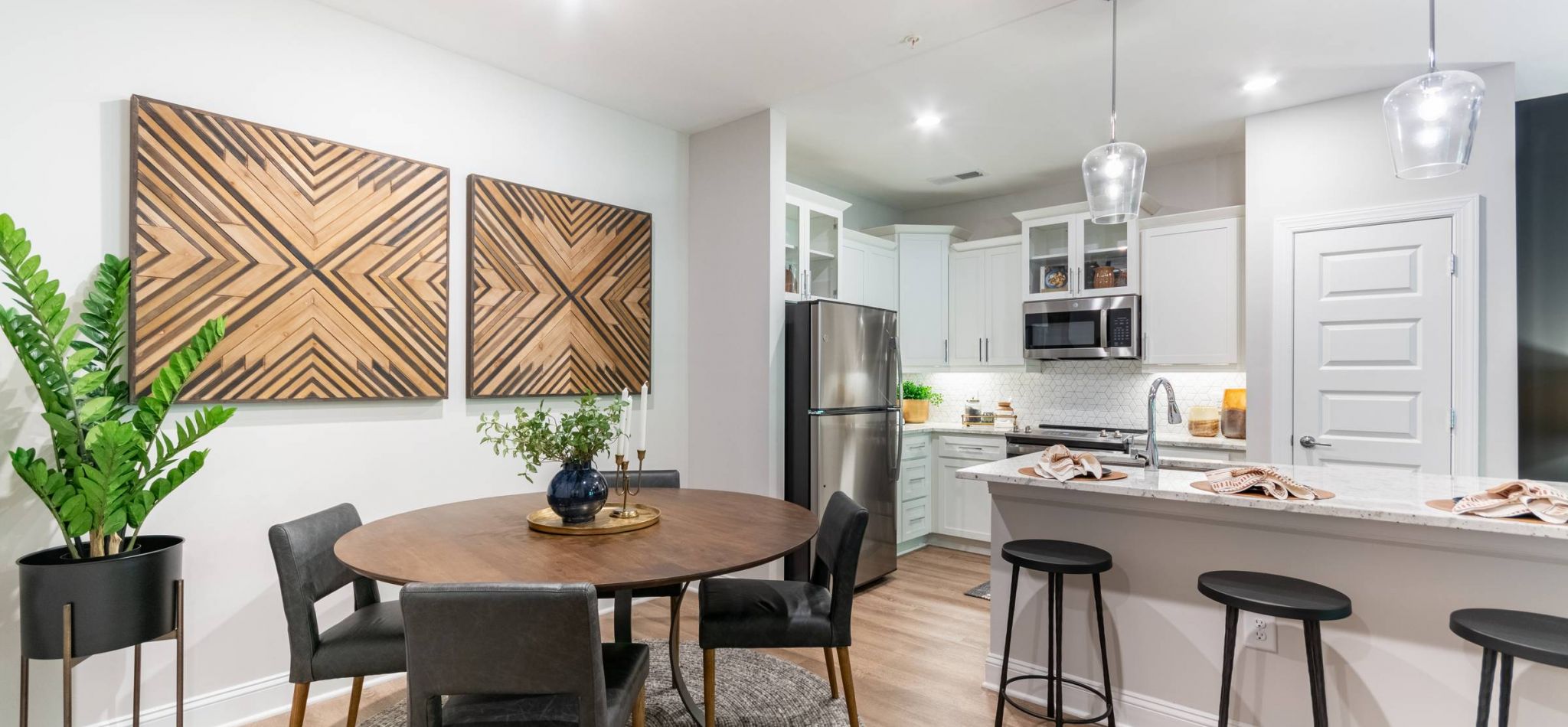 Hawthorne Northwest apartment kitchen interior with kitchen island, stainless steel appliances, and white cabinetry