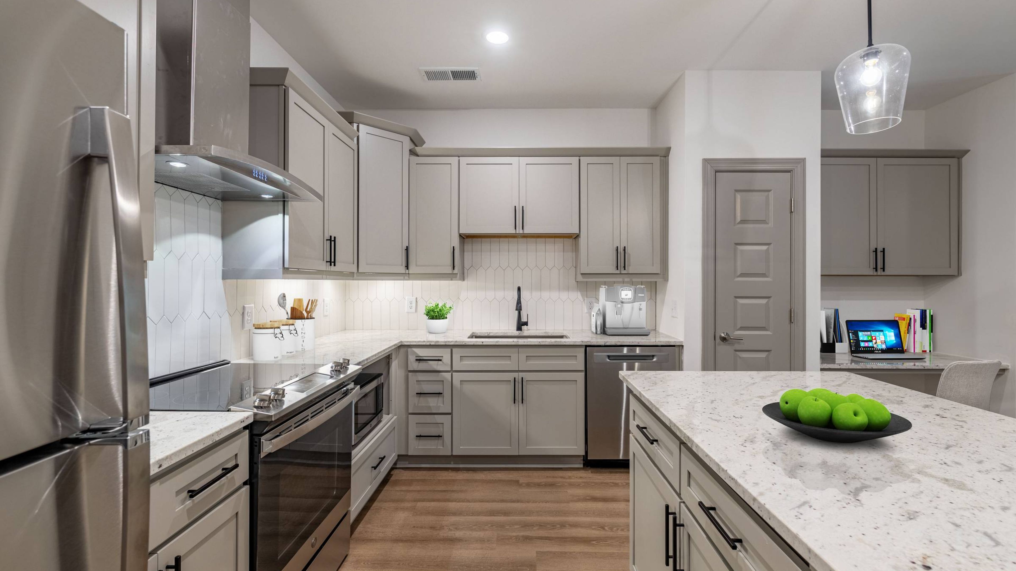 Hawthorne Northwest modern kitchen featuring sleek cabinetry, stainless steel appliances, and a spacious island with an adjacent built-in office nook.